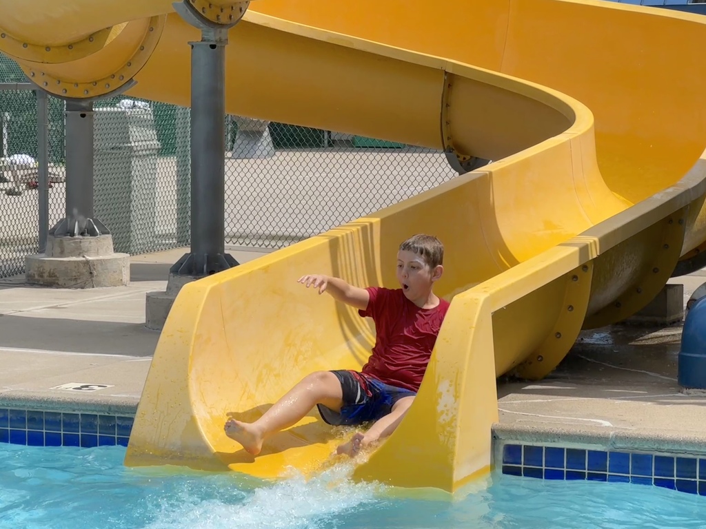 child goes down water slide 