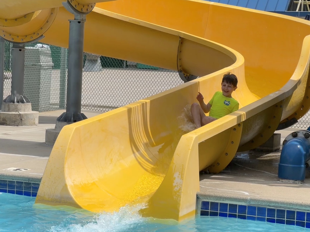 child goes down water slide 