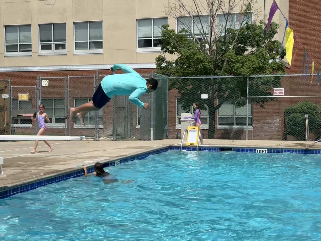child flips from diving board into pool