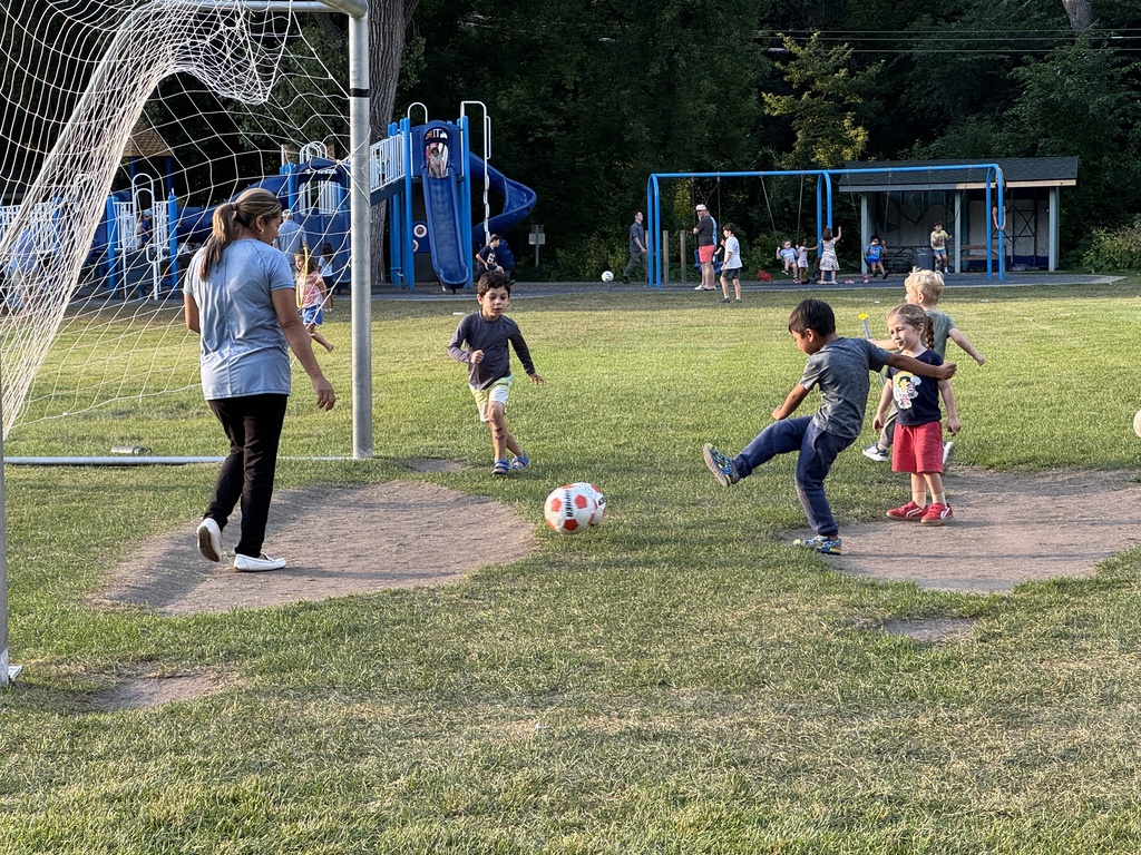 kids place soccer with a parent