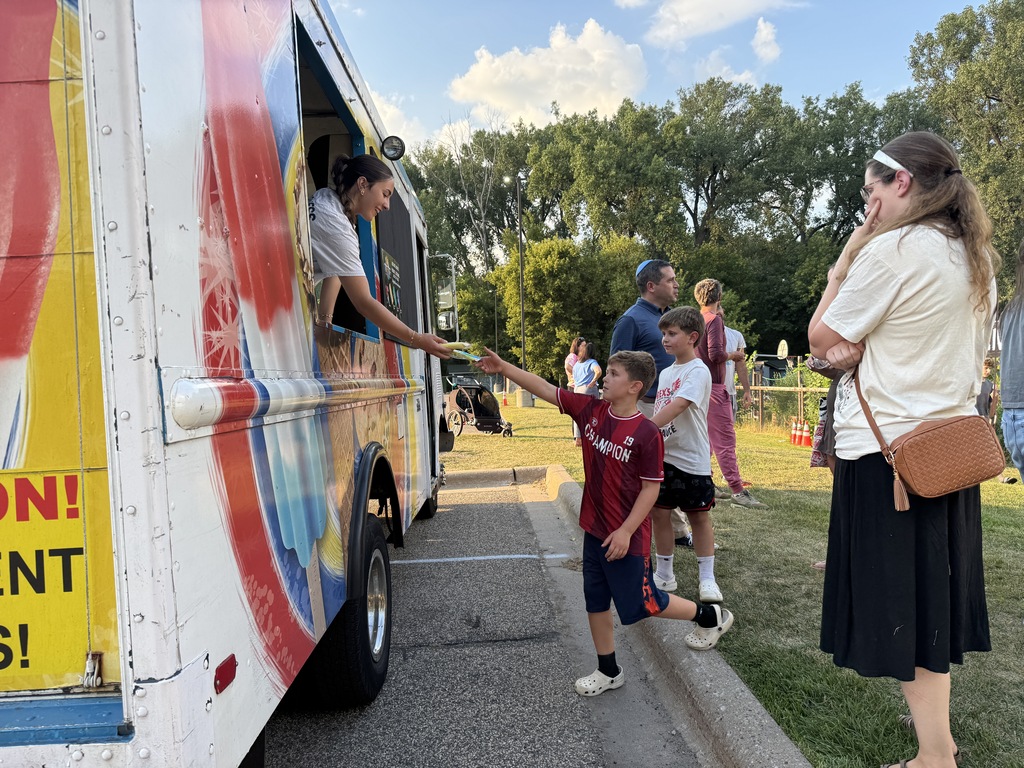 student gets ice cream from ice cream truck
