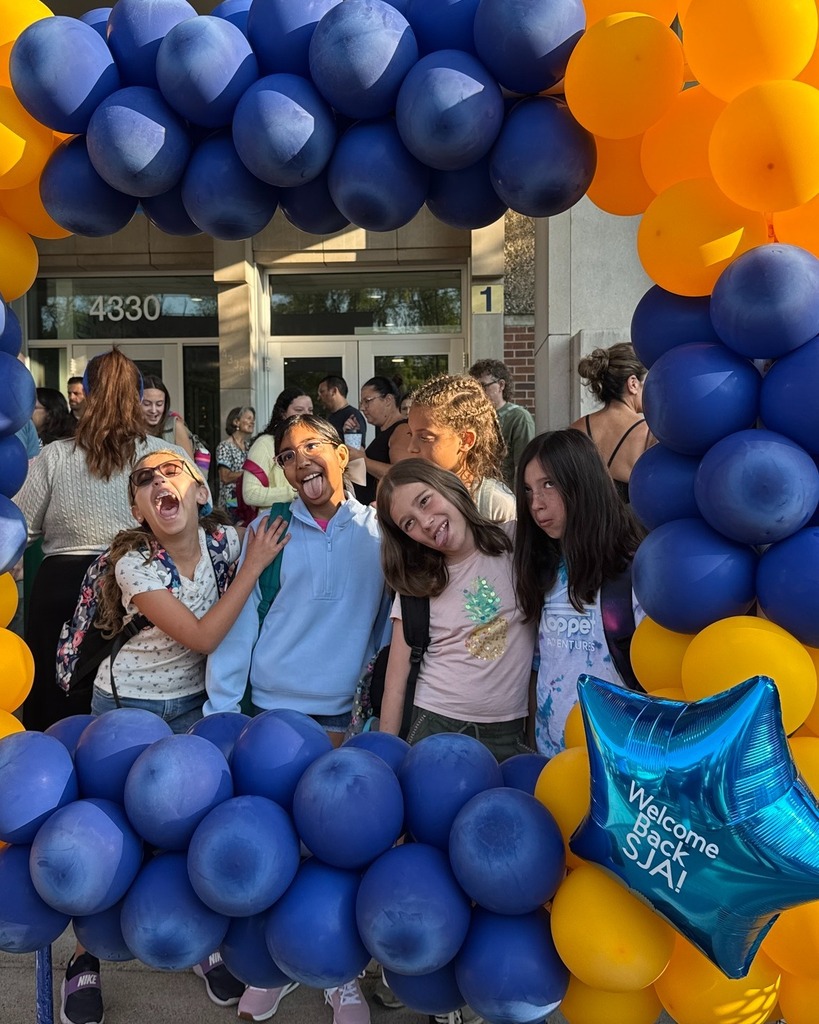 five students make silly faces in blue and gold balloon frame