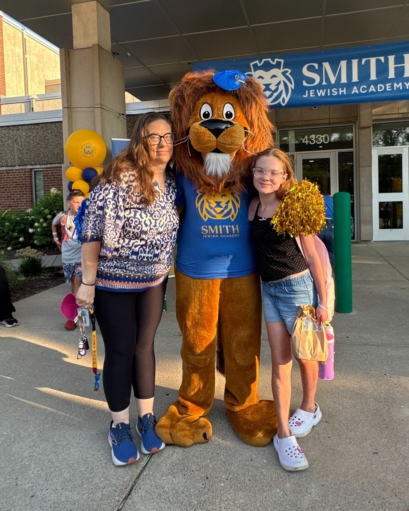 teacher/parent and child pose with Roary the Lion