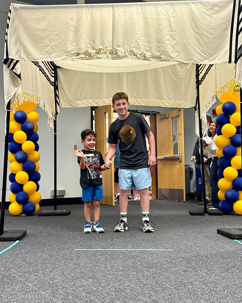eighth grader with kindergarten buddy under chuppah