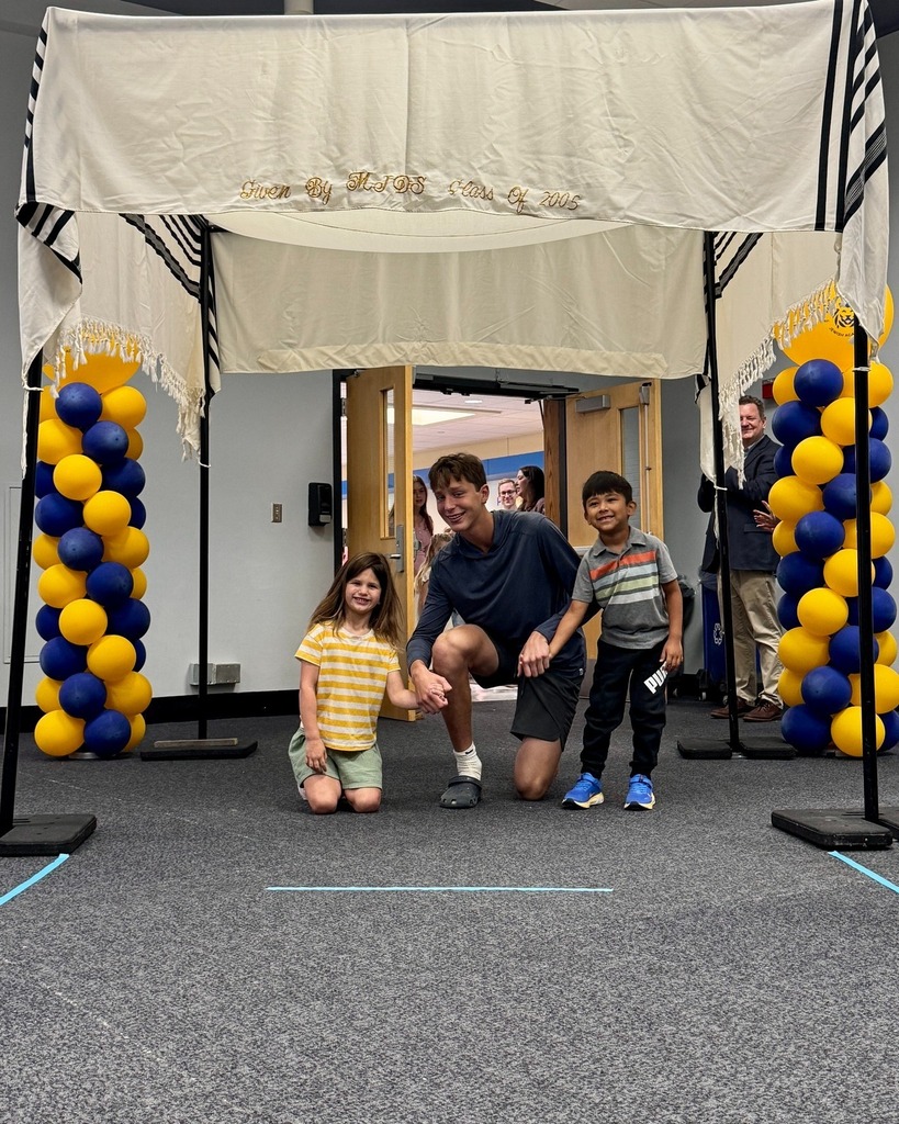eighth grader with kindergarten buddies under chuppah