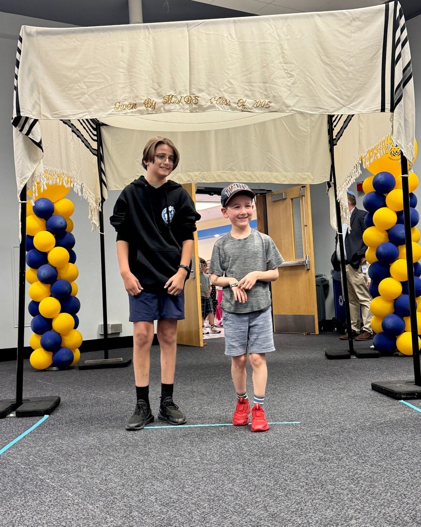 eighth grader with kindergarten buddy under chuppah