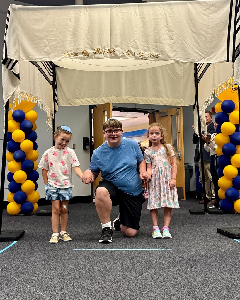 eighth grader with kindergarten buddies under chuppah