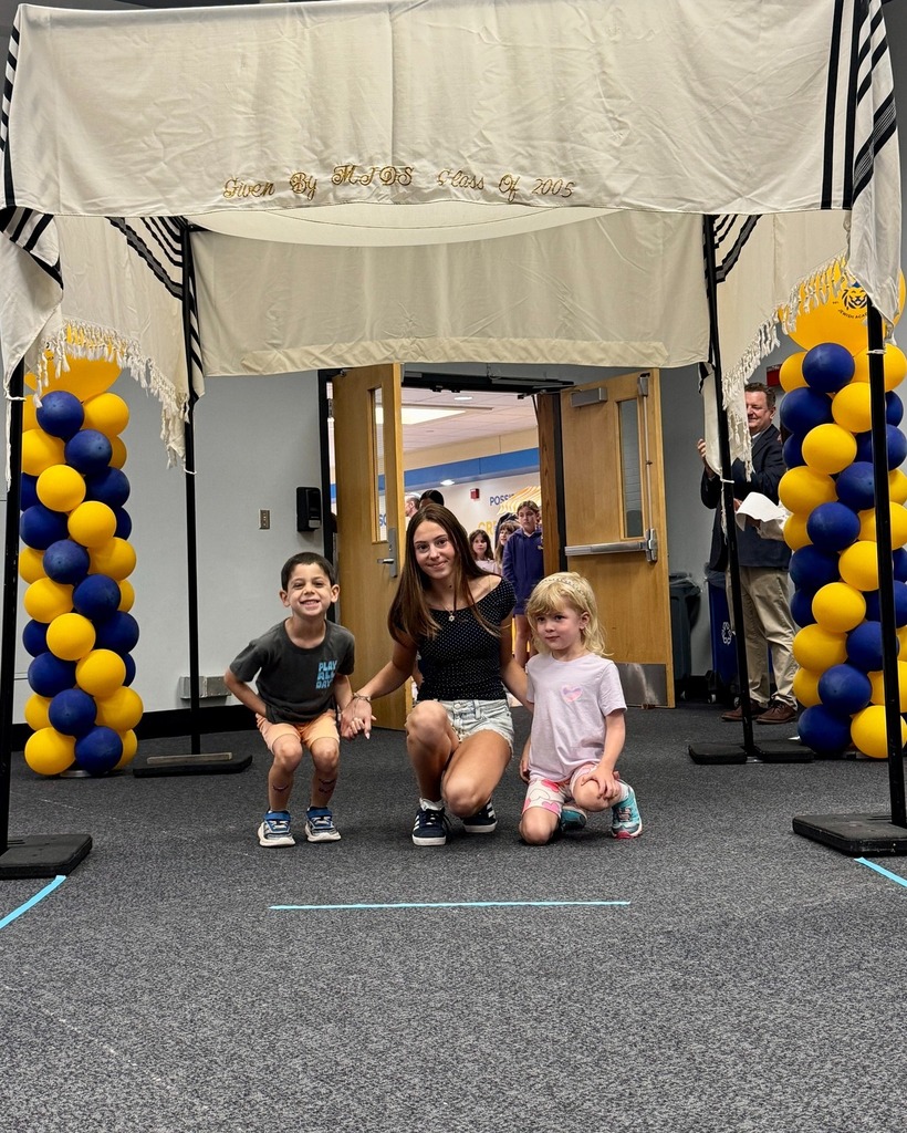 eighth grader with kindergarten buddies under chuppah