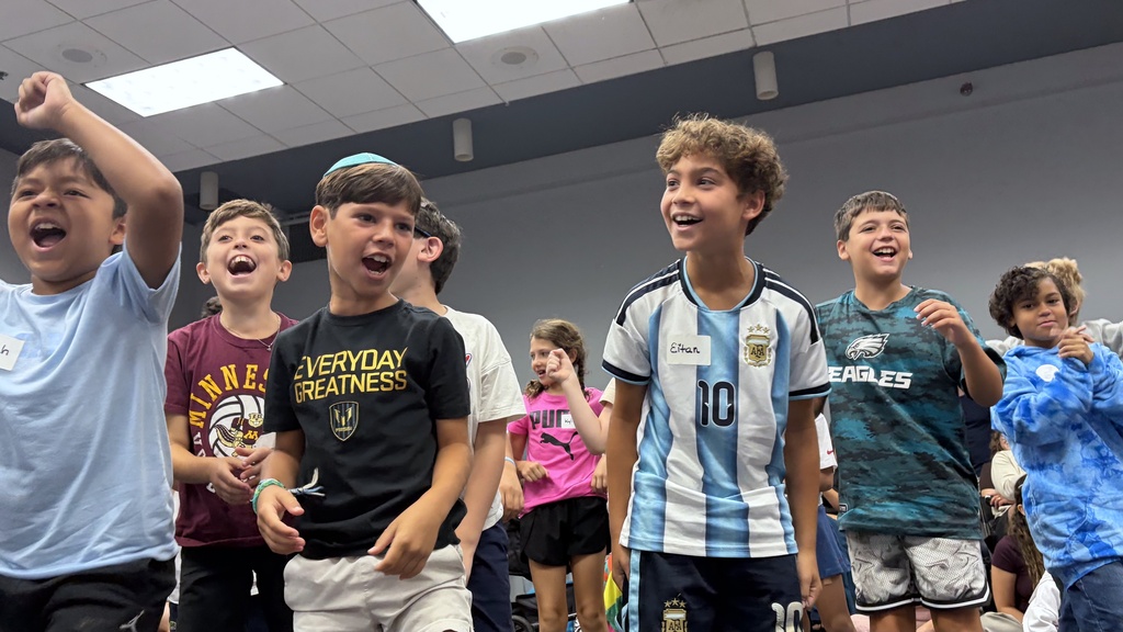 fourth grade students jump and cheer