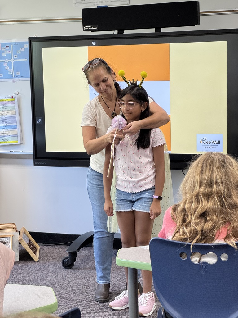 educator crowns a student queen bee