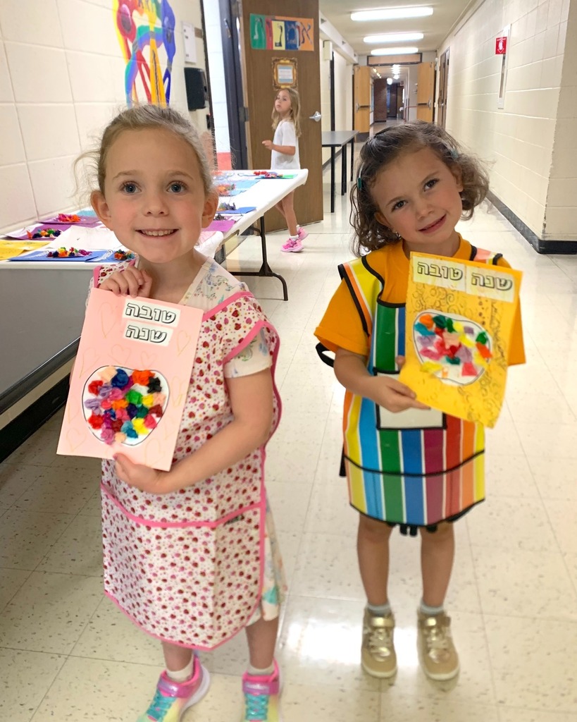 students hold up handmade Rosh Hashanah cards