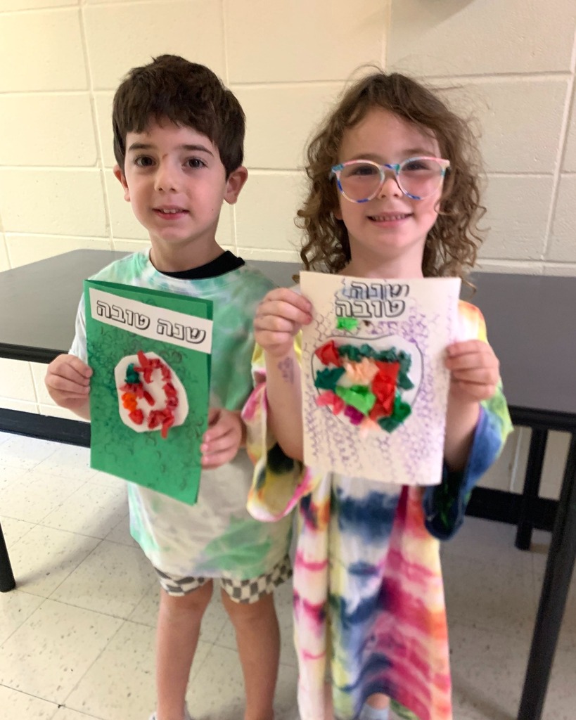 students hold up handmade Rosh Hashanah cards