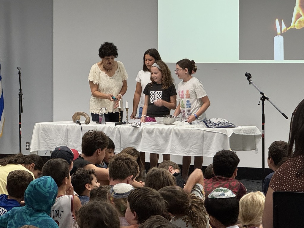 teacher light shabbat candles, students lead blessing