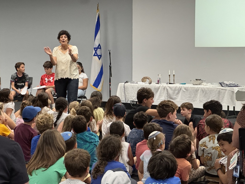 teacher claps hands, leads song