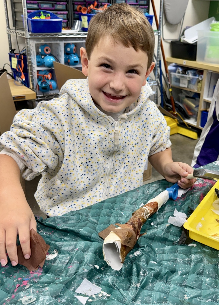 smiling student makes homemade kazoo/paper-mache shofars