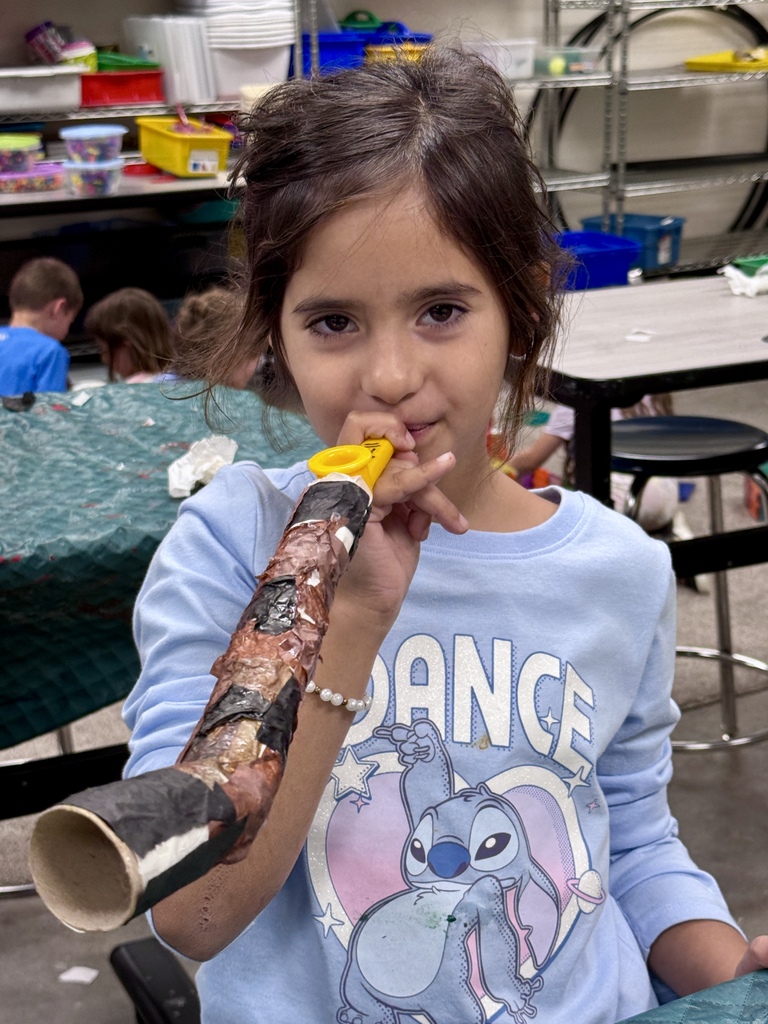 student blows homemade kazoo/paper-mache shofar