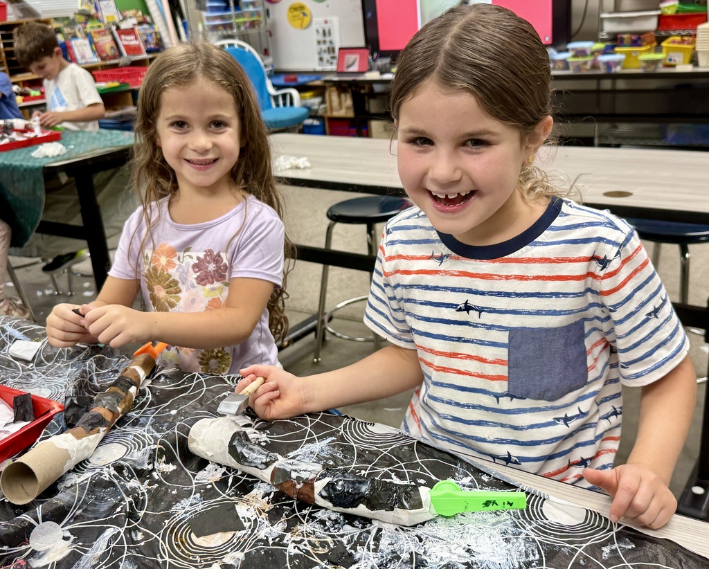 smiling students make homemade kazoo/paper-mache shofars