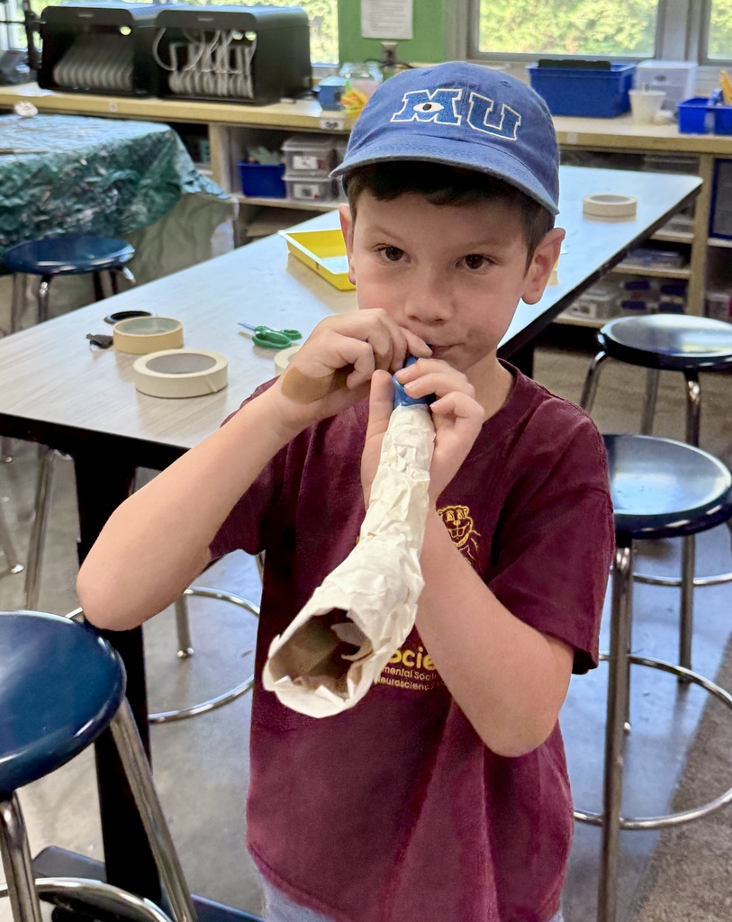 student blows homemade kazoo/paper-mache shofar
