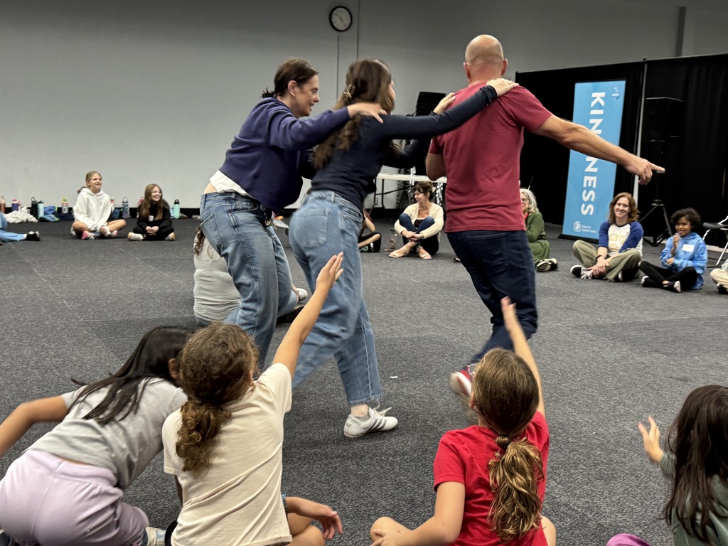 leaders form train and high five students