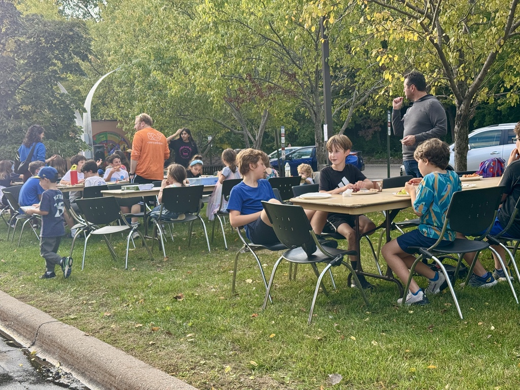 students enjoy pizza outdoors