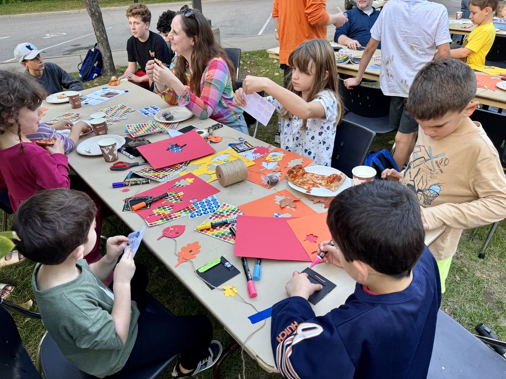 students decorate photo frames and garlands to display in sukkah