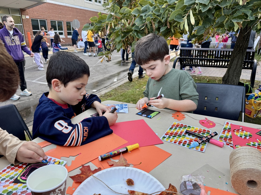 students decorate photo frames to display in sukkah