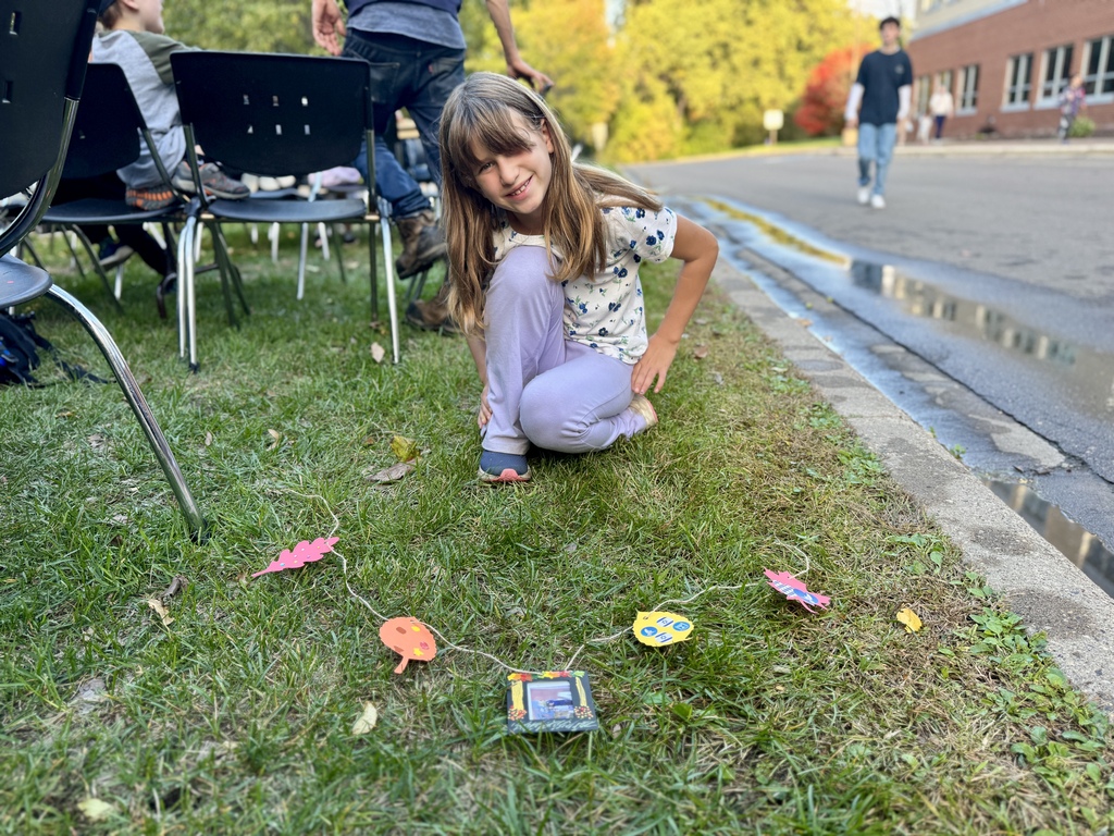 student poses with her sukkah garland art project
