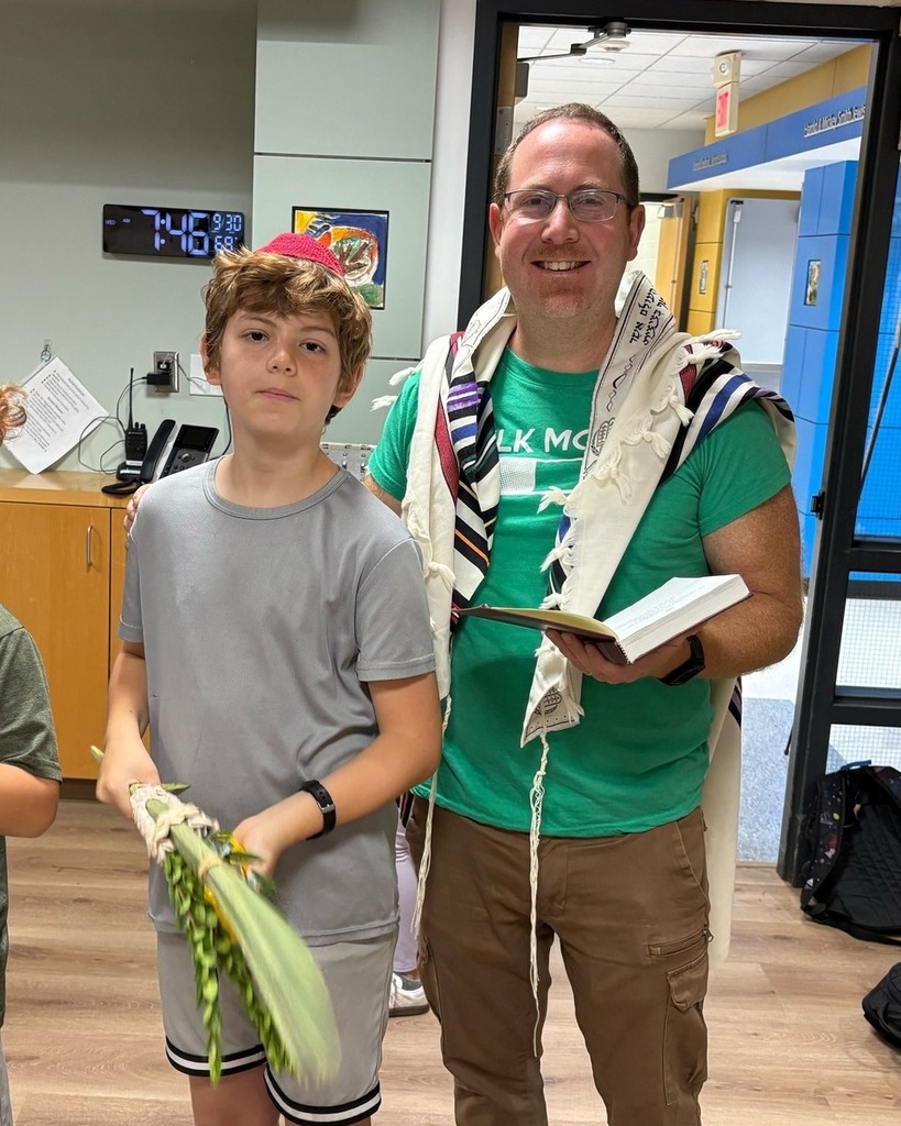 father and son with prayer book, lulav, and etrog