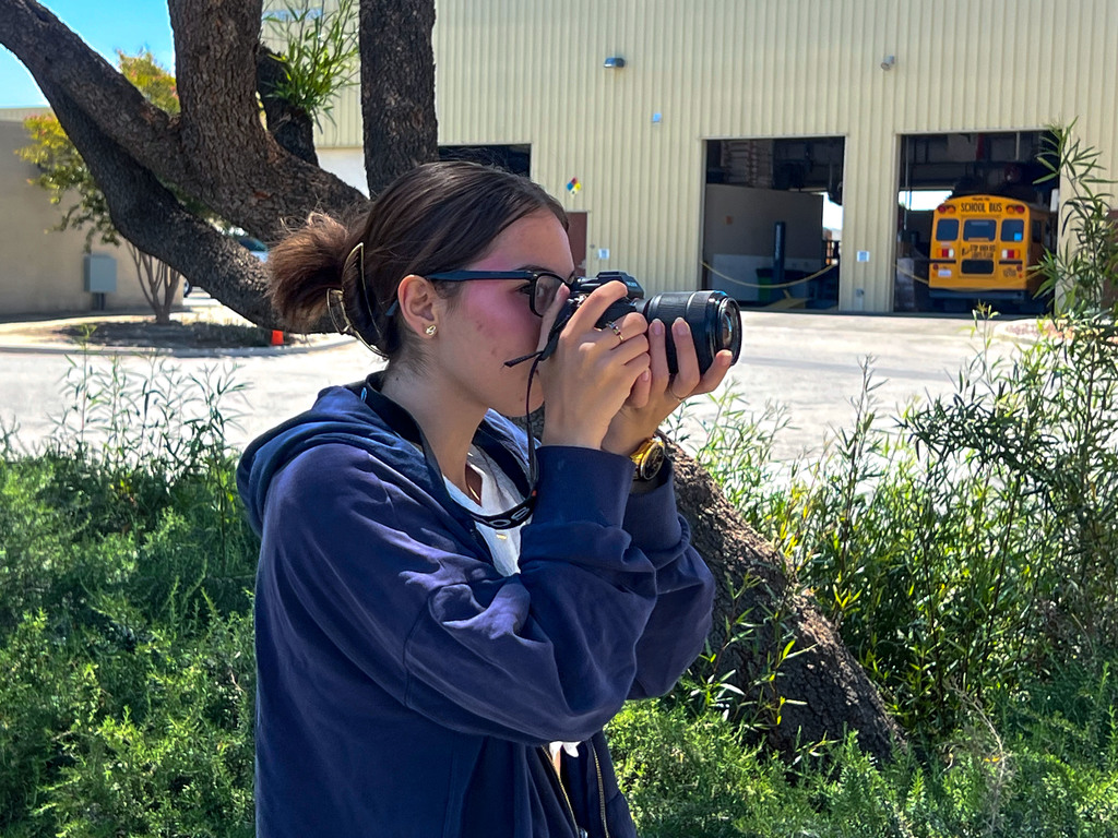 Communications intern taking pictures with camera