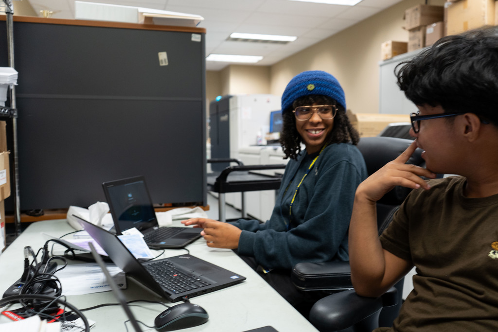 Publication student interns discussing project.