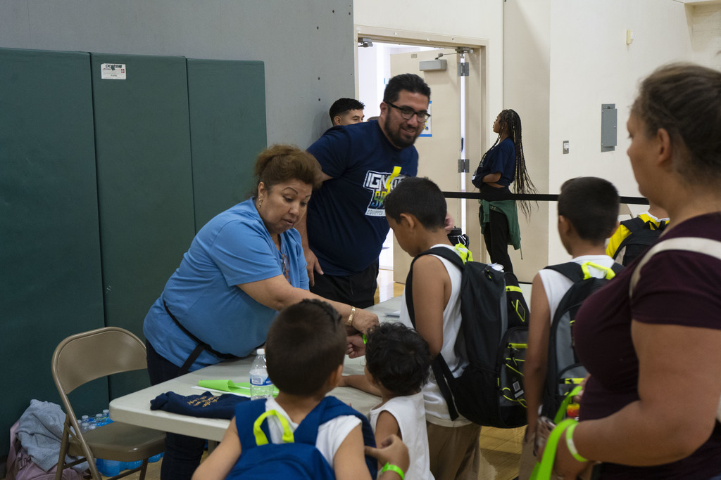 Students receiving new shoes at the back to school resource fair