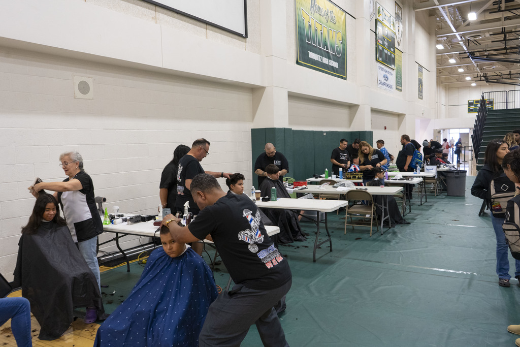 Students receiving hair cuts at resource fair