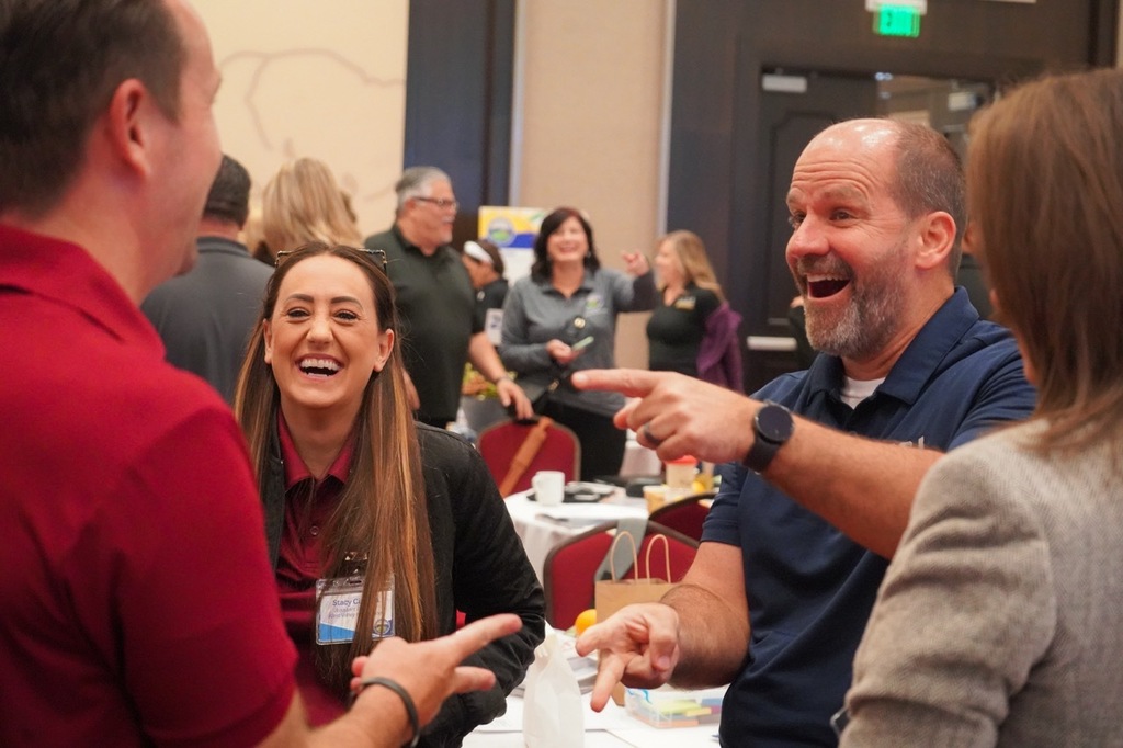 staff laughing and pointing in small group
