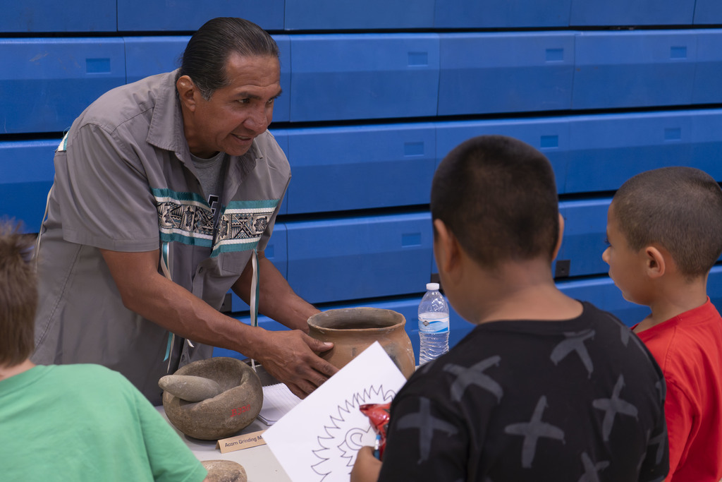 Members of local native american tribes present cultural practices and artifacts to students