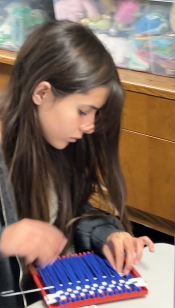 Paying close attention as she weaves.
