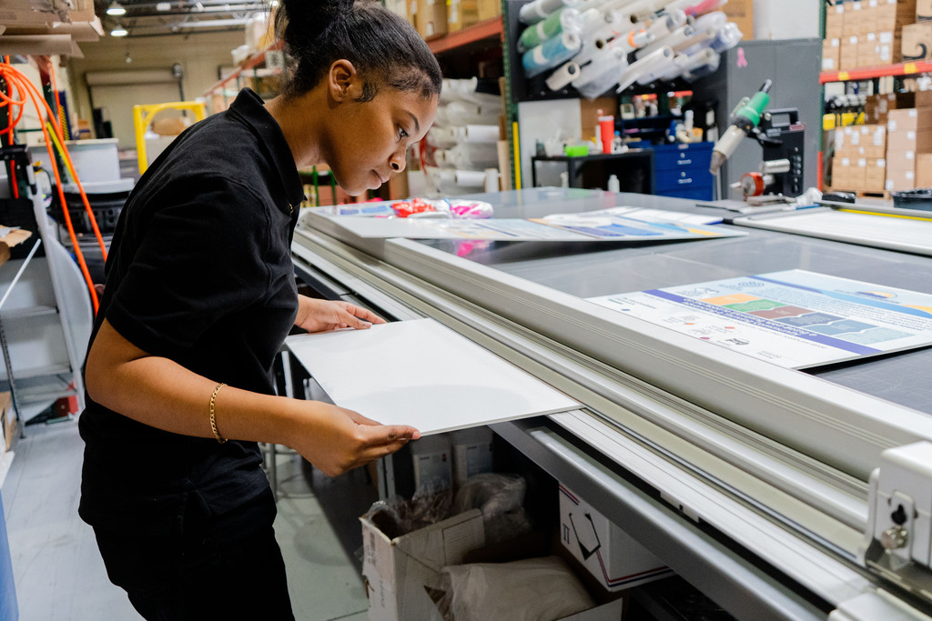 Intern student working on Print Shop machine.