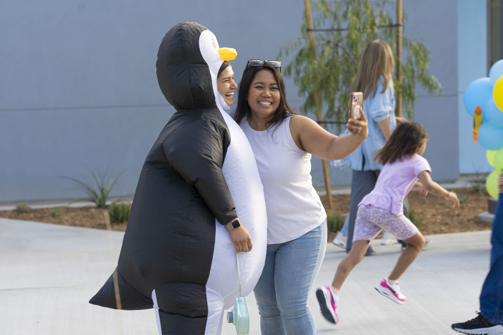 Pleasant Valley Elementary school mascot, the penguin posing for photos with parents