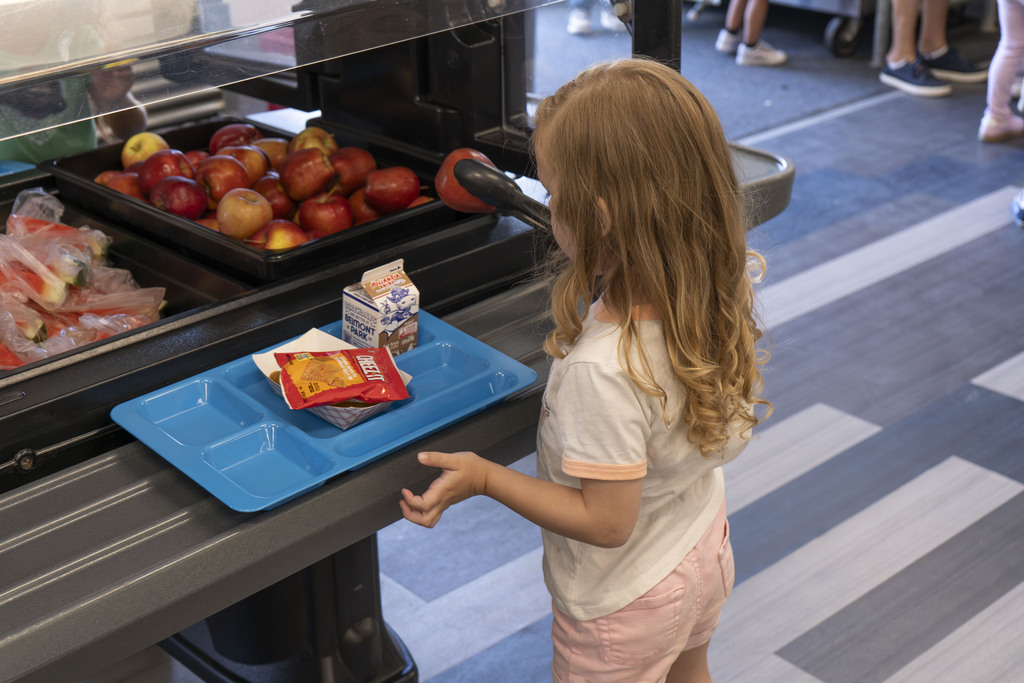 student getting an apple for lunch