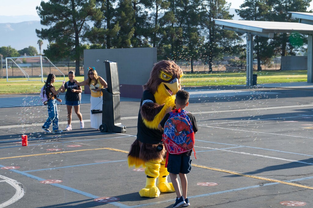 Fallon the Falcon greets a student