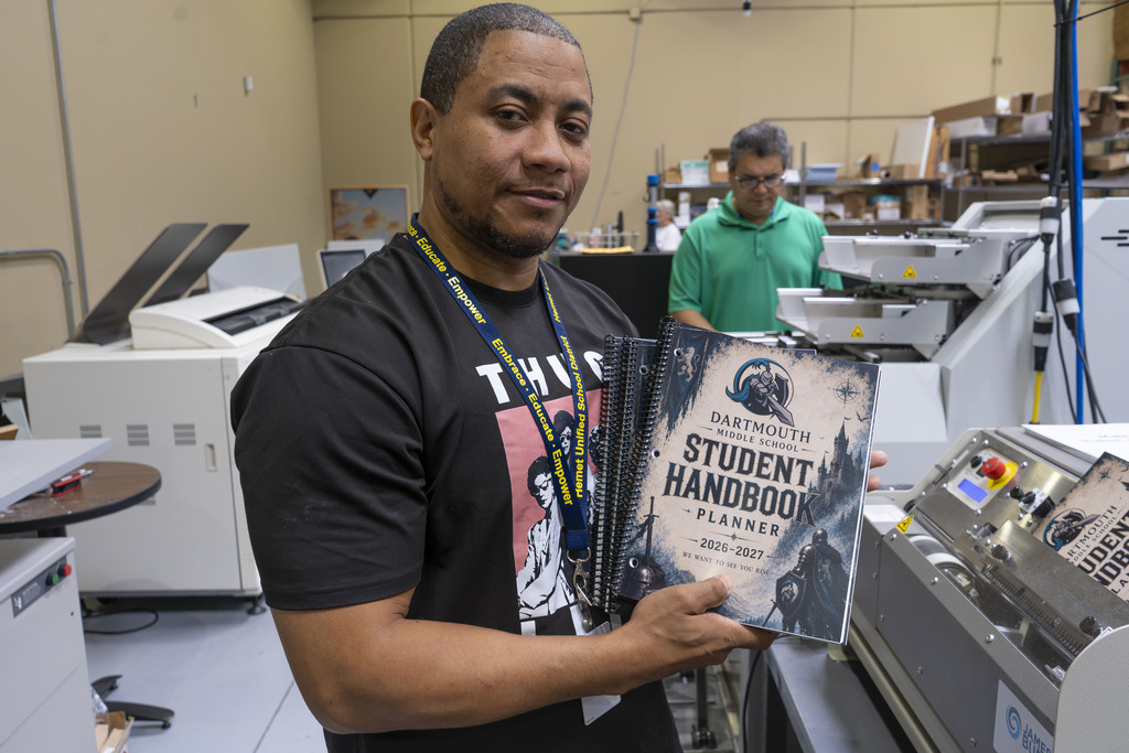 Print Shop staff with a student planner