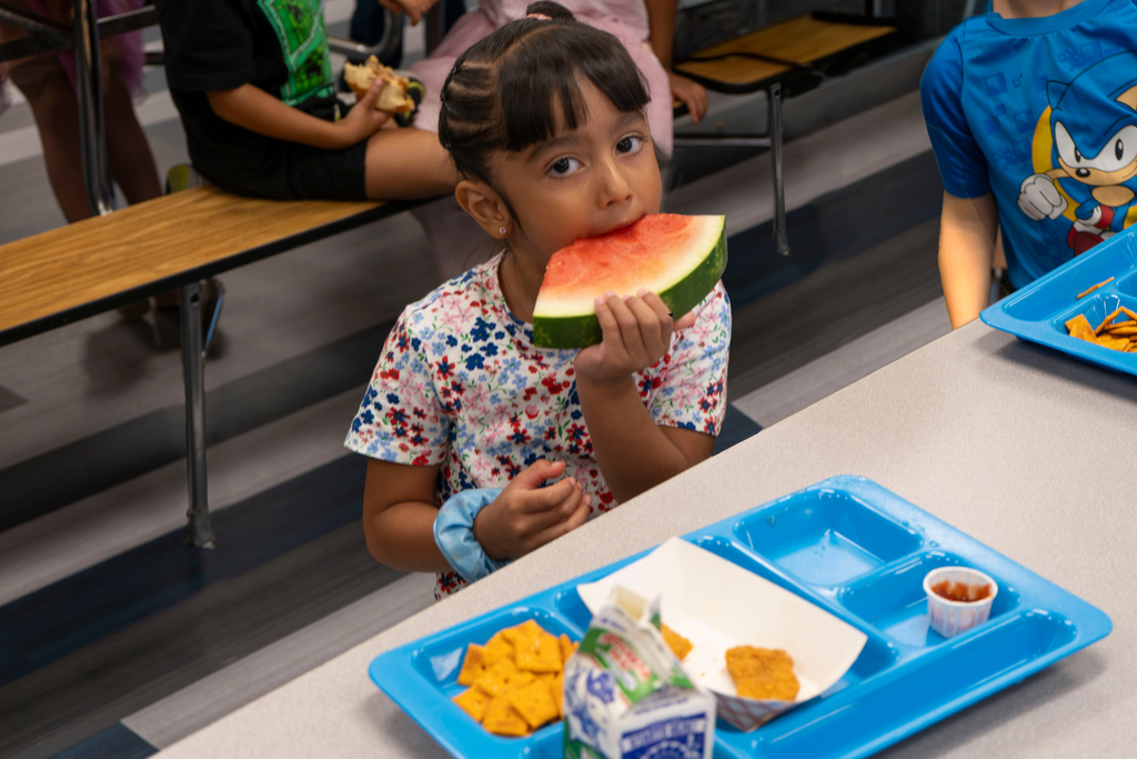 Student eating watermelon at lunch