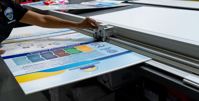 Intern student working on Print Shop machine.