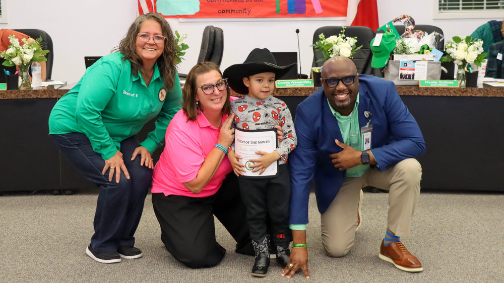 HES Student of the month with Board President and Superintendent