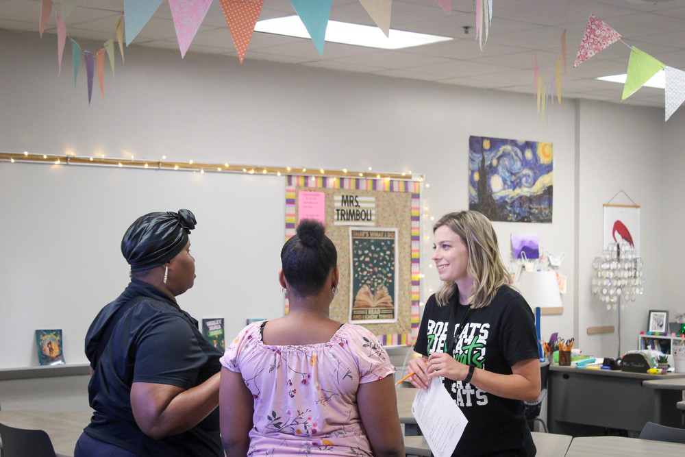 Teacher talking to student and parent
