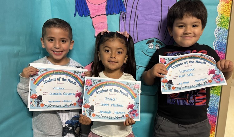 students of the month holding their certificate.