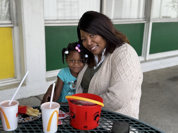 students eating with their families