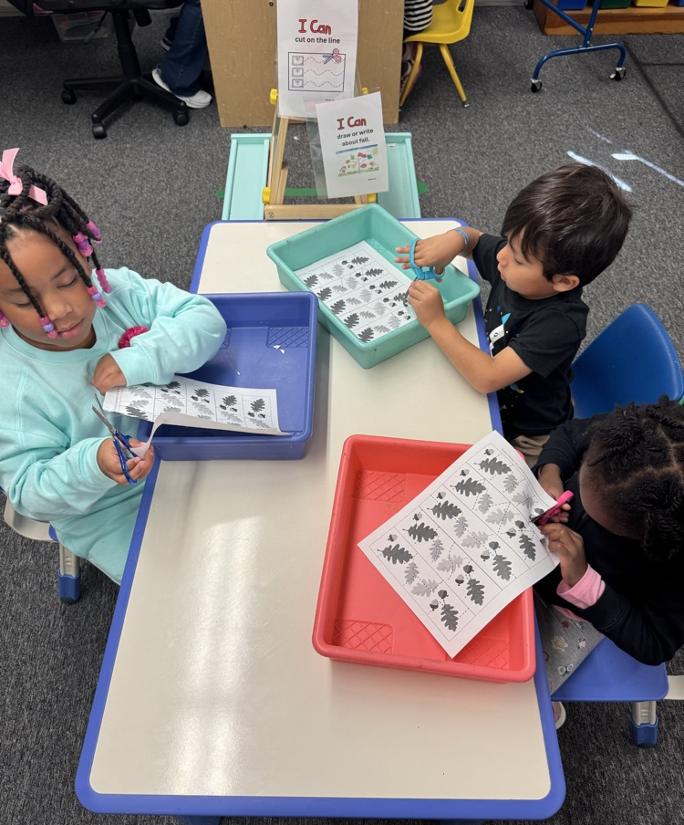 students cutting with scissors