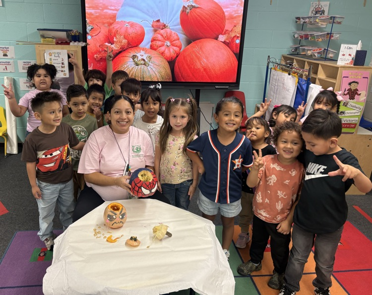 students posing with the pumpkins