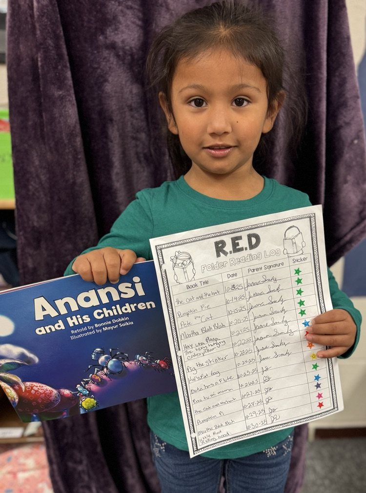 a RED winner holding her book