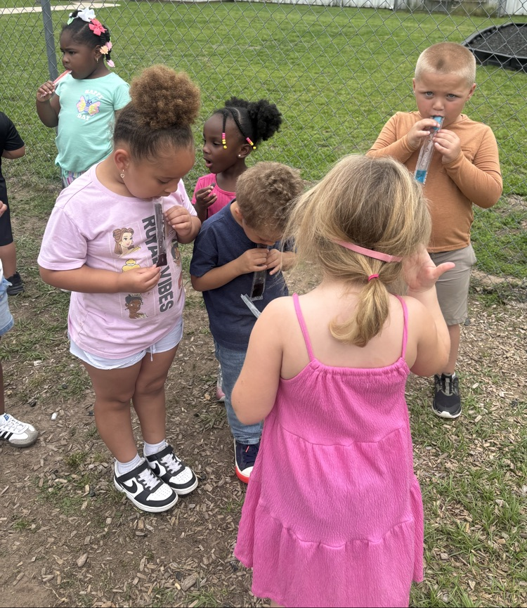 students holding ice pops